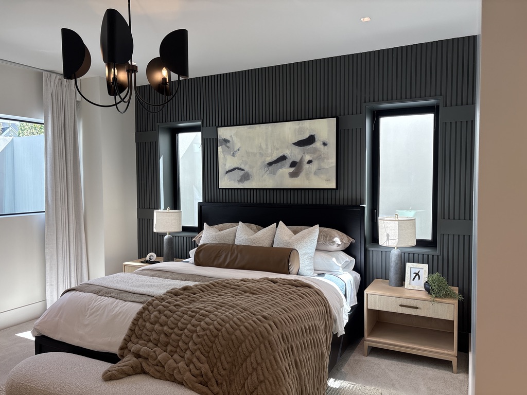 Custom dark slat wall accent wall with integrated millwork, luxury primary bedroom