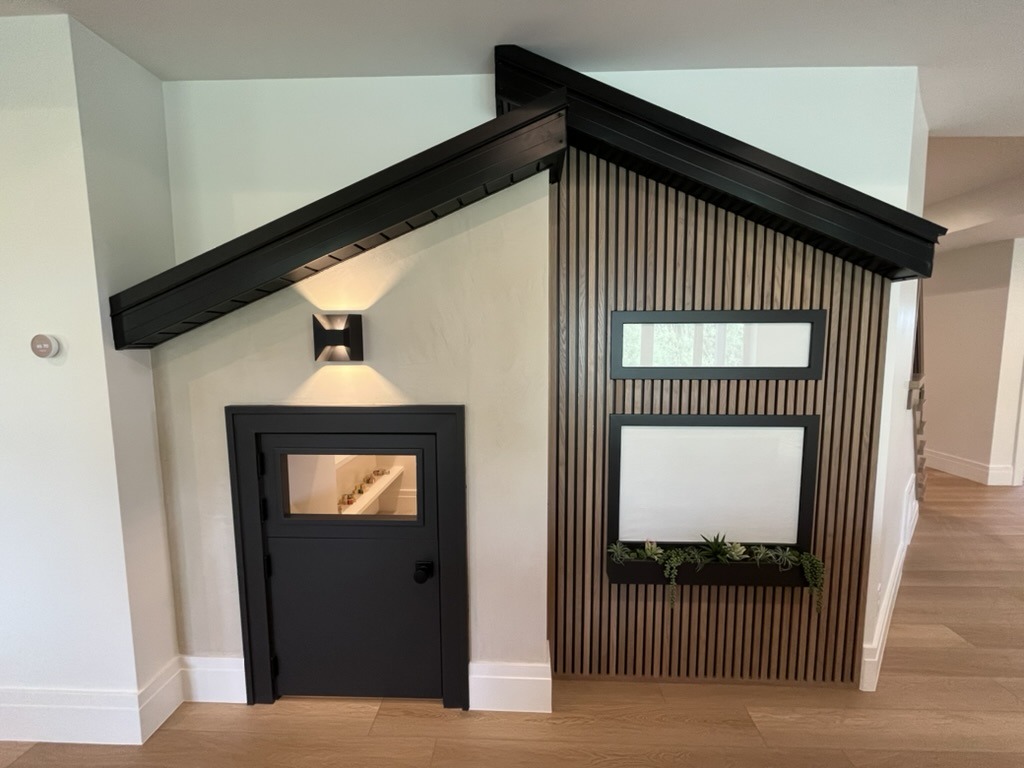 Under-stair playhouse with slat wall and custom trim