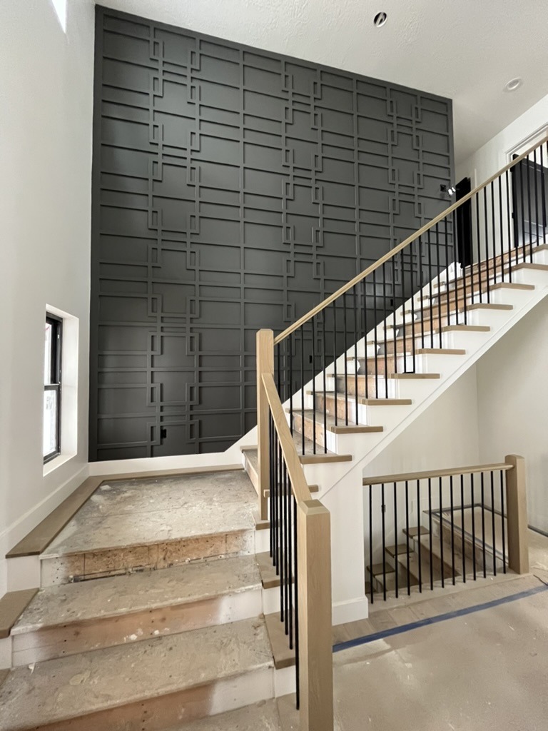 Geometric accent wall and stair rail, custom home
